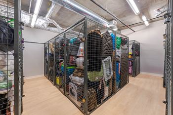 A room with a lot of storage cages filled with various items.